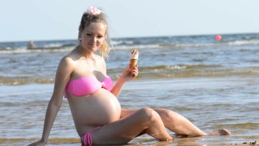 April 24 pregnant in swimwear