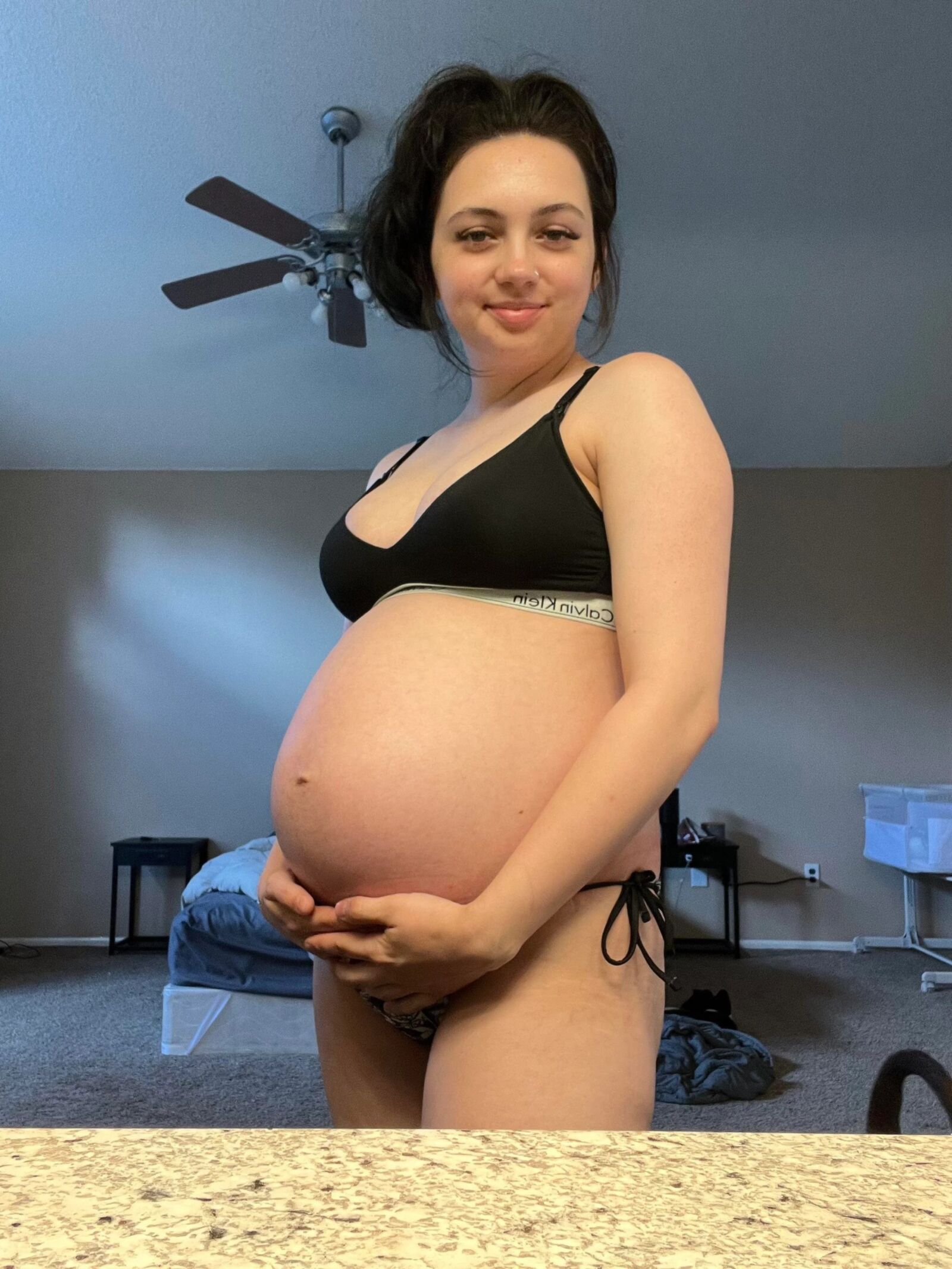 Pregnant young mom at home