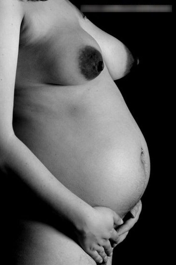 Photo shoot of a naked and anonymous pregnant woman