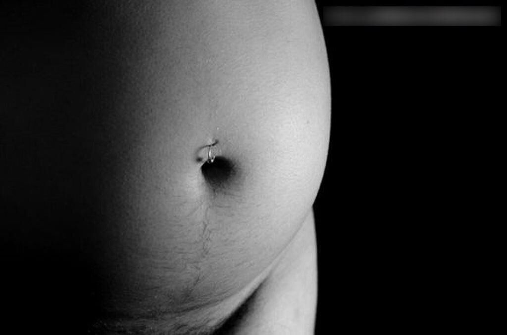 Photo shoot of a naked and anonymous pregnant woman