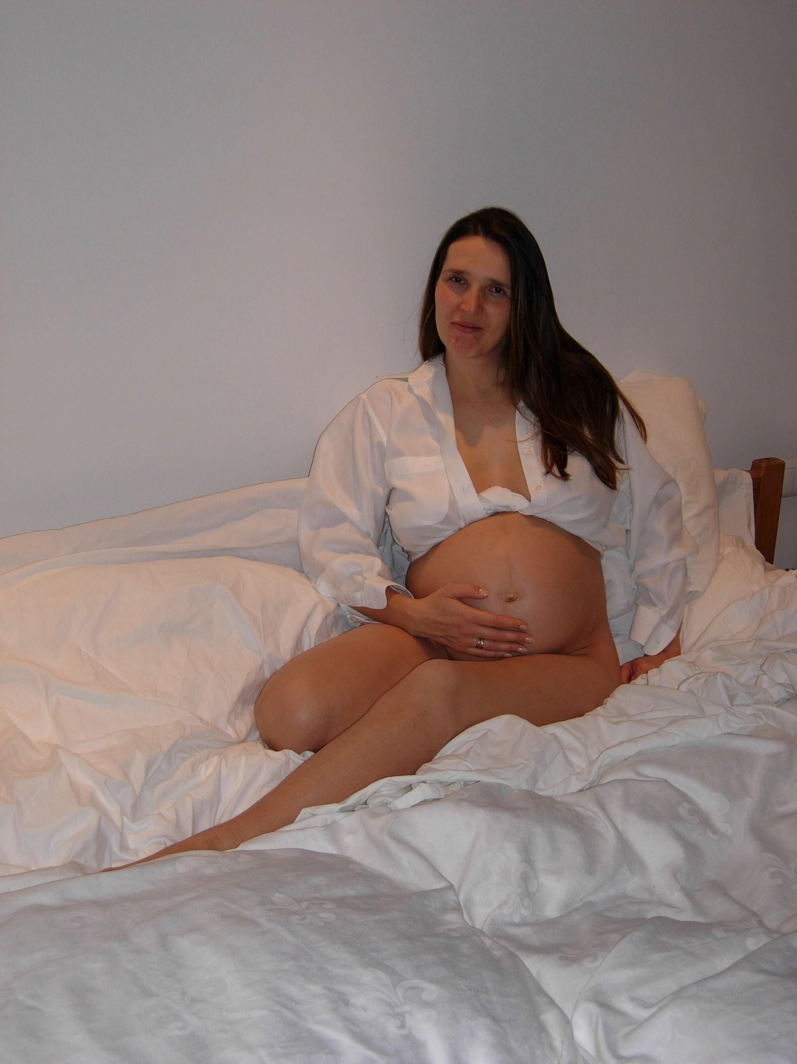 [Pregnant] woman in her bedroom