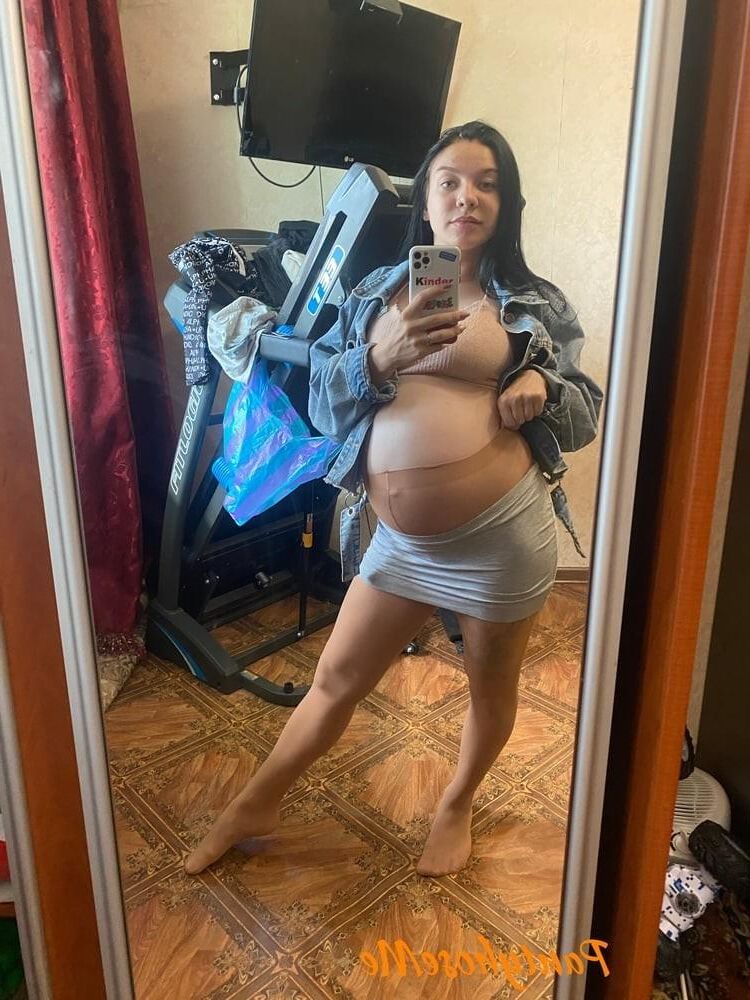 Pregnant brunette in sheer pantyhose