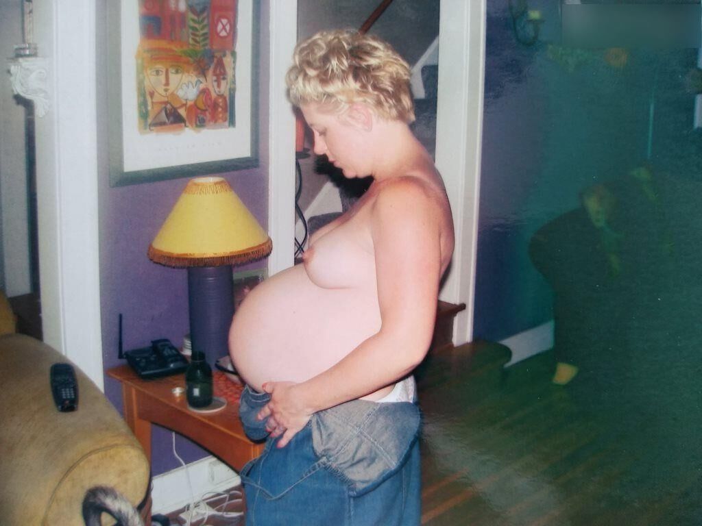 Pregnant woman shows herself at home