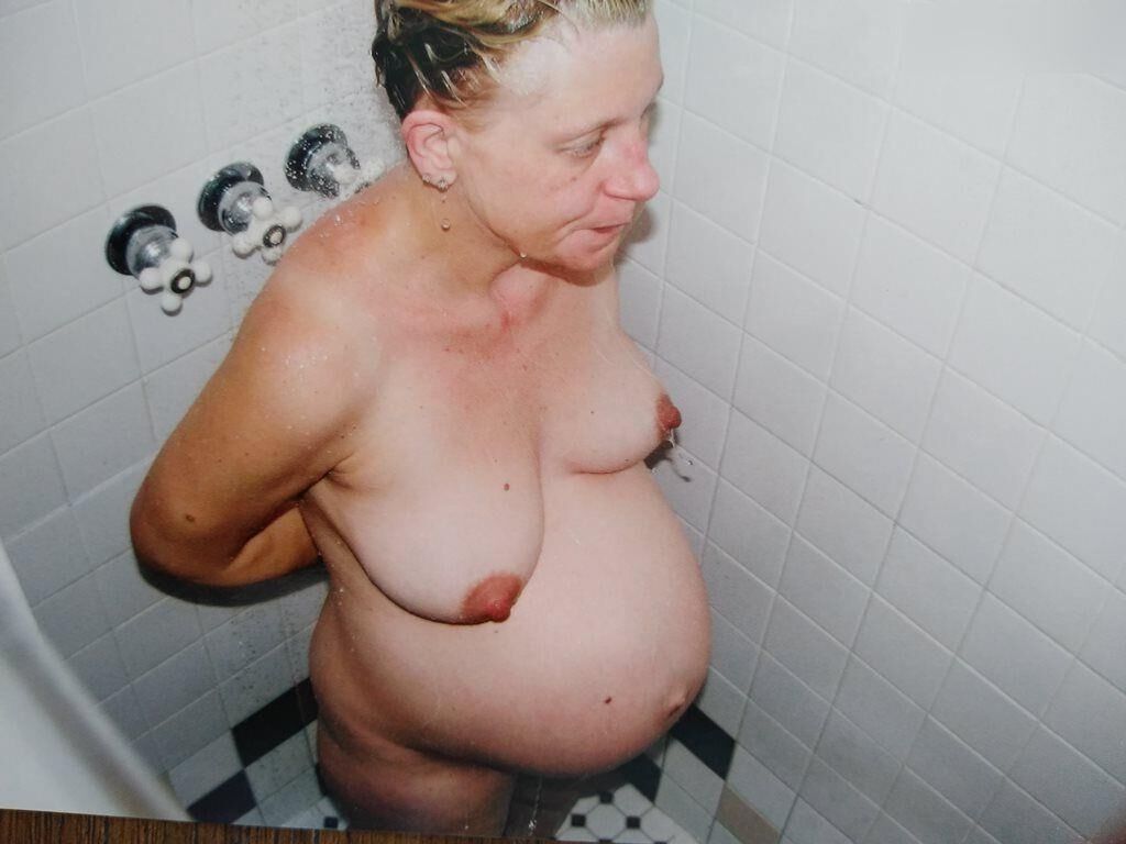 Pregnant woman shows herself at home