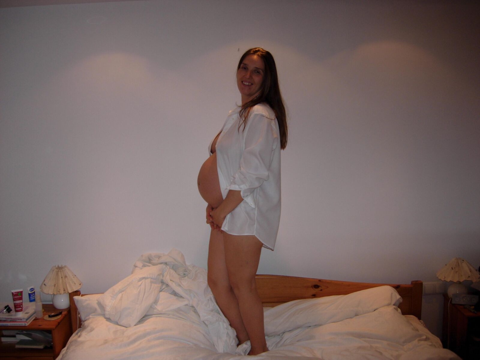 [Pregnant] woman in her bedroom