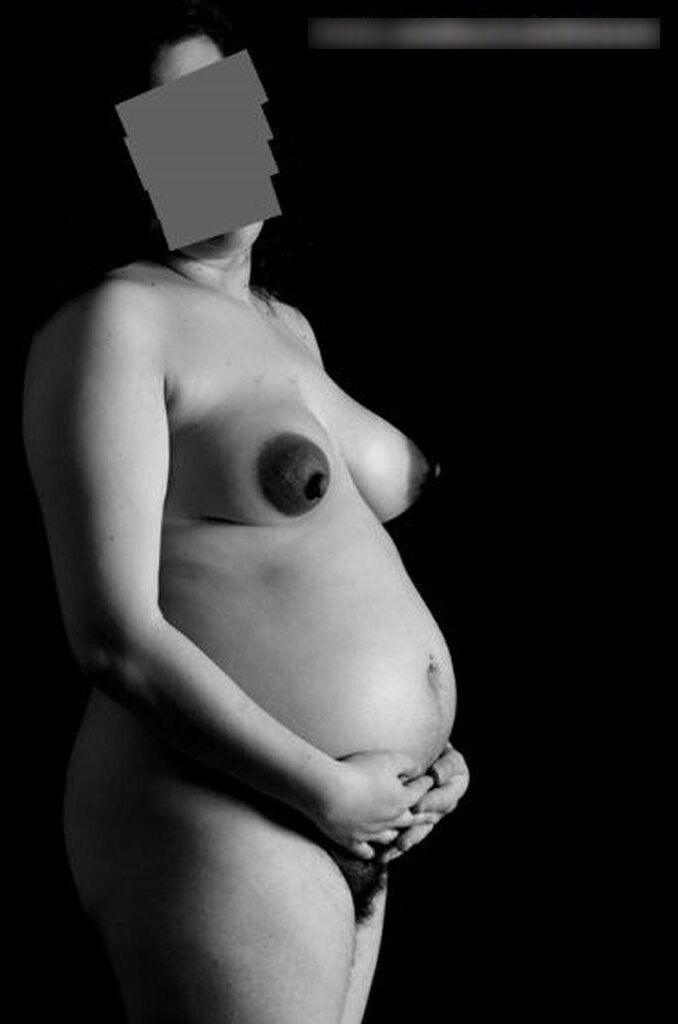 Photo shoot of a naked and anonymous pregnant woman