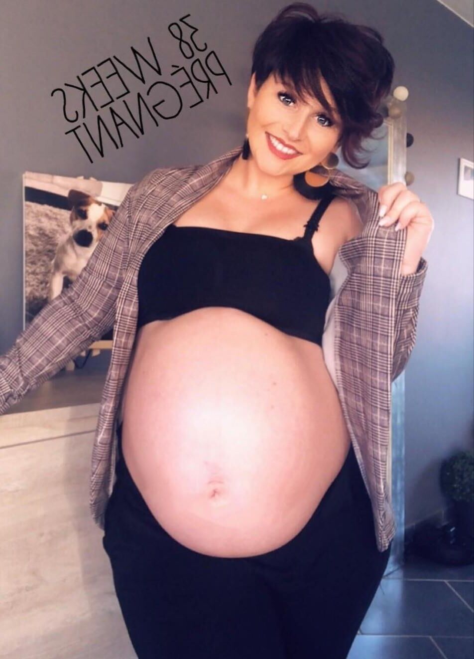 [Pregnant] woman very proud to show off her big belly