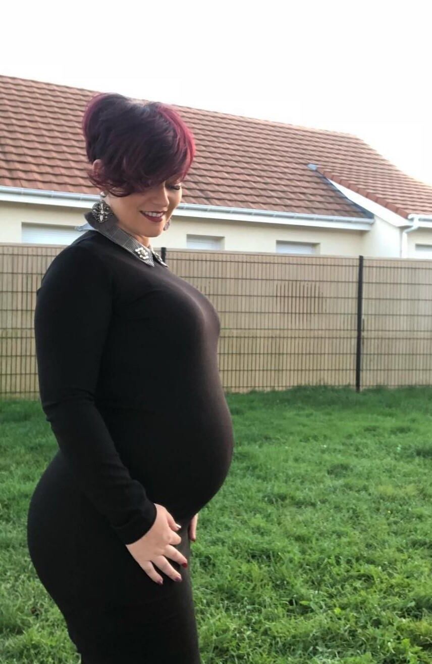 [Pregnant] woman very proud to show off her big belly