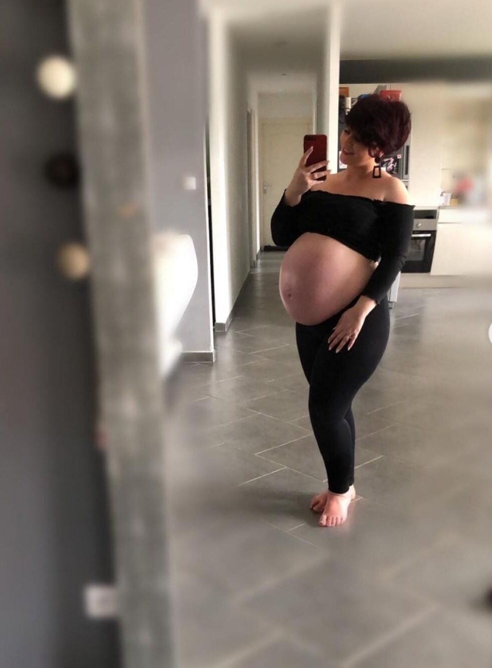 [Pregnant] woman very proud to show off her big belly