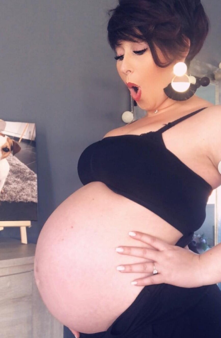 [Pregnant] woman very proud to show off her big belly