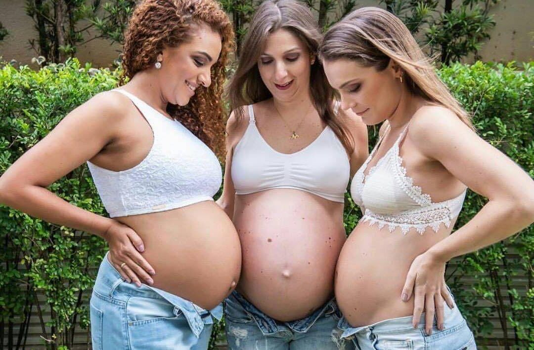 Multiple pregnant bellies - group