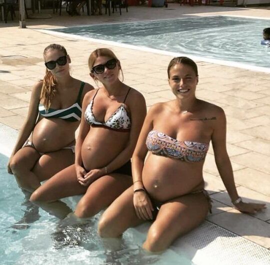 Multiple pregnant bellies - group