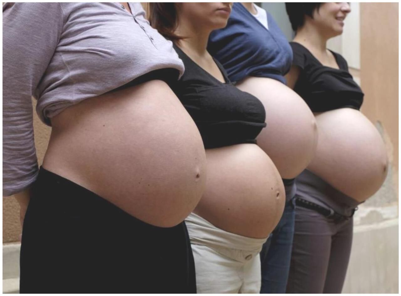 Multiple pregnant bellies - group