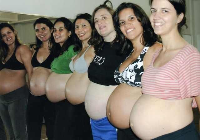 Multiple pregnant bellies - group