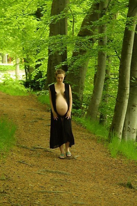 Pregnant girlfriend poses outside