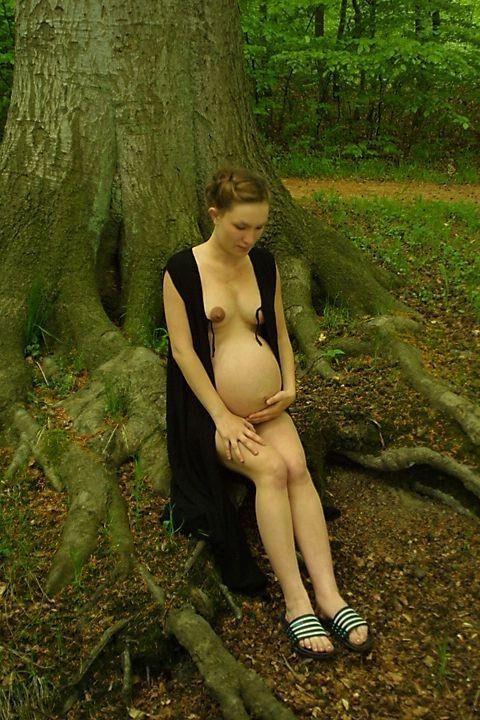 Pregnant girlfriend poses outside